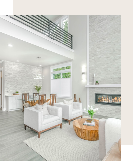 Modern living room renovation by Becker Services featuring double-height ceilings, stone fireplace, and Scandinavian-inspired furniture with wood accents.