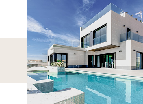 Modern luxury home with glass balcony and private swimming pool under a clear blue sky.